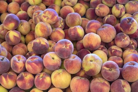 Peaches close up. Early morning in farmers market. Colorful fruit background の写真素材