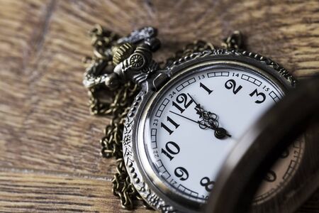 Antique Pocket Watch wood on tumbled tableの写真素材