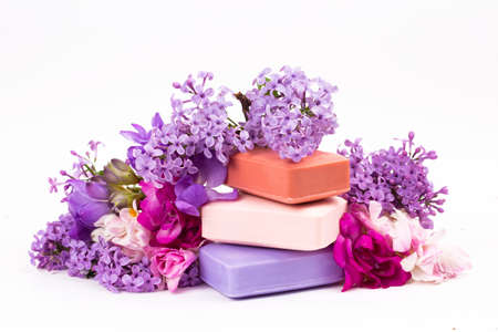 Natural handmade soap and lilac flowers on white backgroundの写真素材