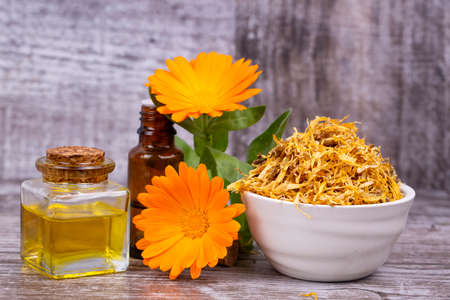 Herbal calendula officinalis in the glass and drop oil Isolatedの写真素材