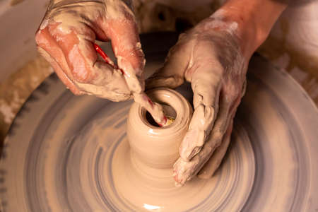 Professional potter making bowl in pottery workshop