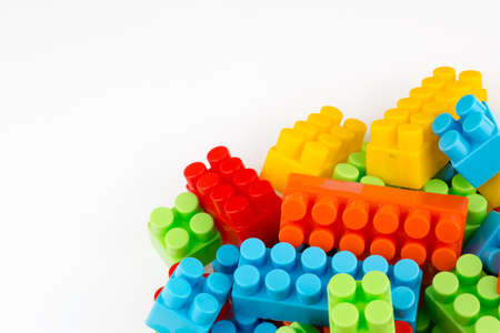 Children toys; colorful plastic blocks on the white background.