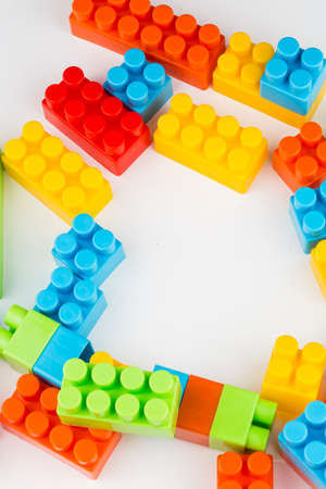 Children toys; colorful plastic blocks on the white background.の写真素材