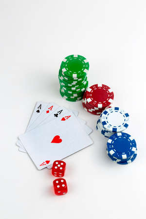 Ace playing cards with red dice. Casino betting and gambling concept and poker chips.の写真素材
