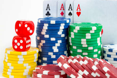 Ace playing cards with red dice. Casino betting and gambling concept and poker chips.