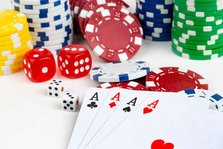 Ace playing cards with red dice. Casino betting and gambling concept and poker chips.の写真素材
