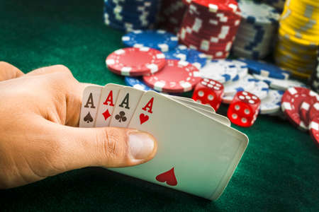 Ace playing cards with red dice. Casino betting and gambling concept and poker chips.