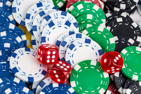 Ace playing cards with red dice. Casino betting and gambling concept and poker chips.