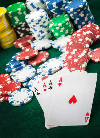 Ace playing cards with red dice. Casino betting and gambling concept and poker chips.