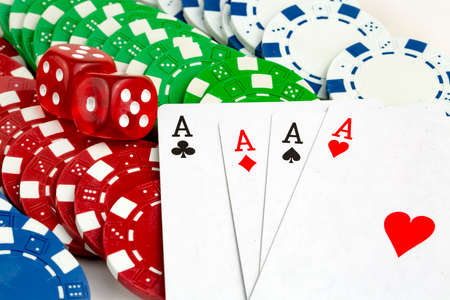 Ace playing cards with red dice. Casino betting and gambling concept and poker chips.
