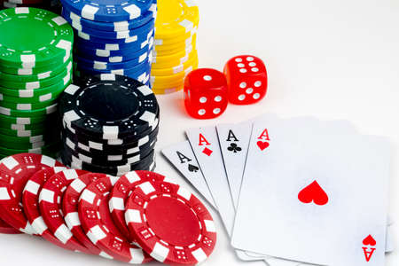Ace playing cards with red dice. Casino betting and gambling concept and poker chips.
