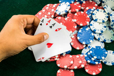 Ace playing cards with red dice. Casino betting and gambling concept and poker chips.