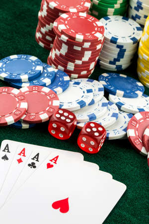 Ace playing cards with red dice. Casino betting and gambling concept and poker chips.
