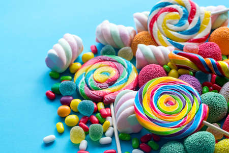 Colorful lollipops and different colored round candy. Top view.の写真素材