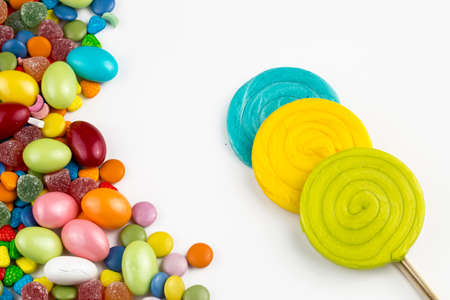 Colorful lollipops and different colored round candy. Top view.
