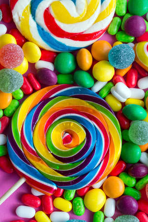 Colorful lollipops and different colored round candy. Top view.の写真素材