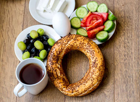 Turkish traditional breakfast with feta cheese, vegetables, olives, simit bagel and tea. Top viewの写真素材