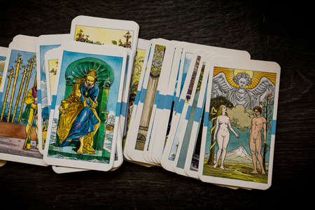 Seamless pattern with old colorful Tarot cards in chaotic layout. Occult, esoteric, divination and wicca concept. Mystic and vintage astrology background for antique decorations, scrapbookingのeditorial素材