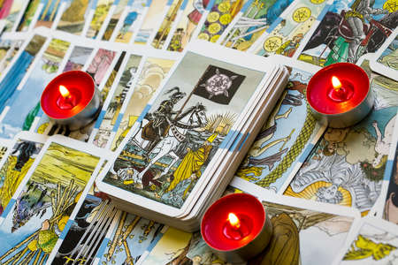 Seamless pattern with old colorful Tarot cards in chaotic layout. Occult, esoteric, divination and wicca concept. Mystic and vintage astrology background for antique decorations, scrapbookingのeditorial素材