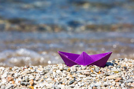 Paper ship and sea. Travel concept photo.の写真素材