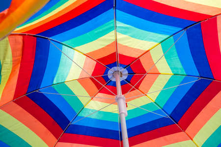 Colorful patterned beach umbrella on the beachの写真素材