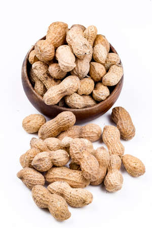 Dried peanuts in closeup on the white background.