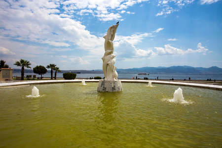 Travel concept photo. Izmir / Karsiyaka / Bostanli / Turkey. Dolphins sculpture.のeditorial素材