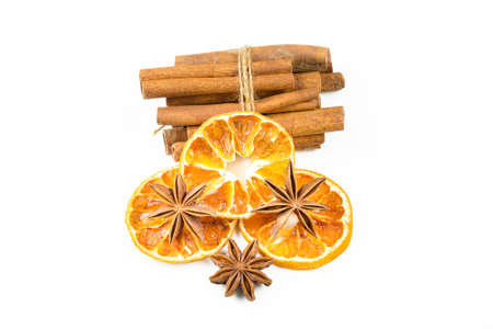 Dried orange slices, cinnamon and star anise isolated on white