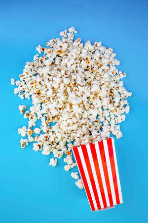 Movie cinema and popcorn concept photo on the blue background