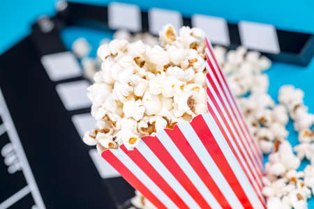 Movie cinema and popcorn concept photo on the blue backgroundの写真素材