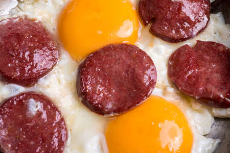 Fried sausage with egg in copper pan turkish mealの写真素材