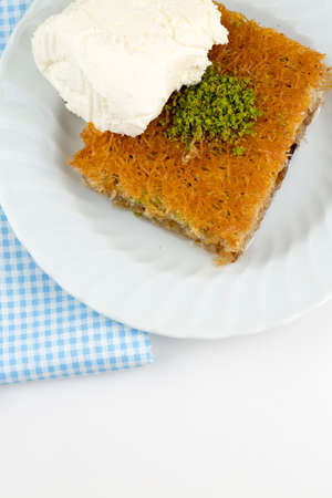 Traditional delicious Turkis dessert; Shredded dough baked in syrup topped with crushed nuts....