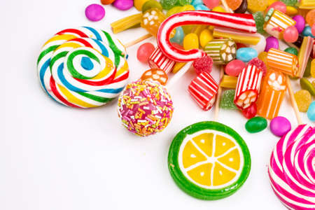 Colorful lollipops and different colored round candy. Top view.