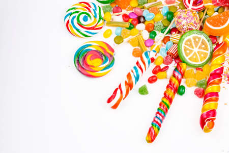 Colorful lollipops and different colored round candy. Top view.