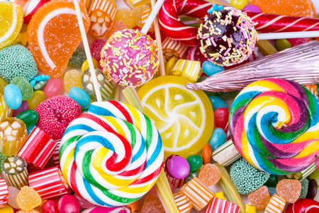 Colorful lollipops and different colored round candy. Top view.