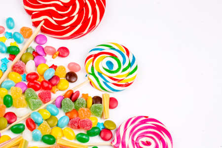 Colorful lollipops and different colored round candy. Top view.の写真素材