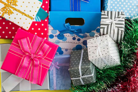 Colorful gift surprise packages, on pink background.