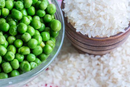 Raw green pea and dried rice. Food concept photo.