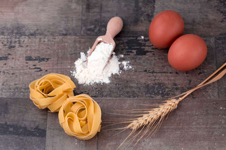 Raw food macaroni in kitchen. Food concept photo.の写真素材