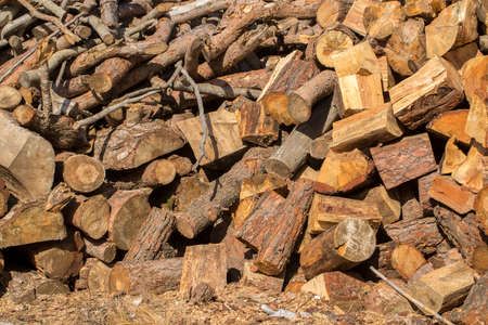 Natural wooden background - closeup of chopped firewood. Firewood stacked and prepared for winter...