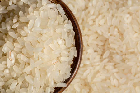 Top view of a heap of raw parboiled rice isolated on white background. Healthy food. Close up, high...