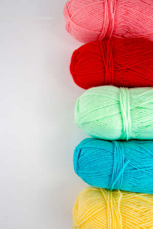 Close up shot of colored wool yarn balls as backgroundの写真素材