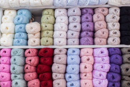Close up shot of colored wool yarn balls as background