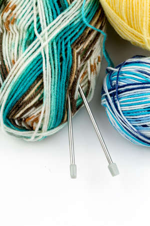Close up shot of colored wool yarn balls as backgroundの写真素材