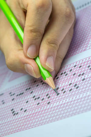 Exams quiz test paper with pencil drawing selected choice on answer sheets at school