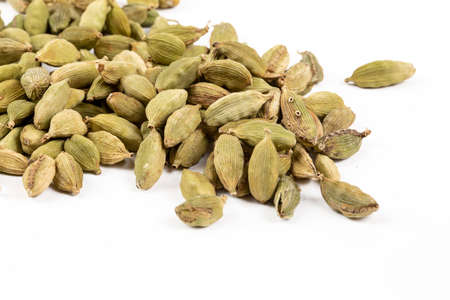 Heap of cardamom seeds isolated on a white background.の写真素材