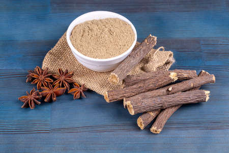 Cloves, anise and cinnamon powder on a blue wooden backgroundの写真素材
