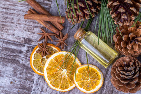 Citrus essential oil in a bottle on a wooden background.の写真素材