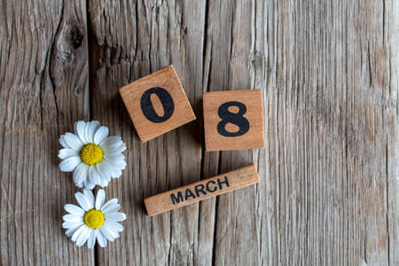 March 8, Number cube with daisy flower on a wooden backgroundの写真素材