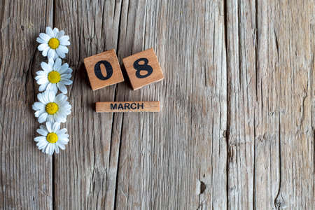 Number 8 with daisies on wooden background, International Women's Dayの写真素材